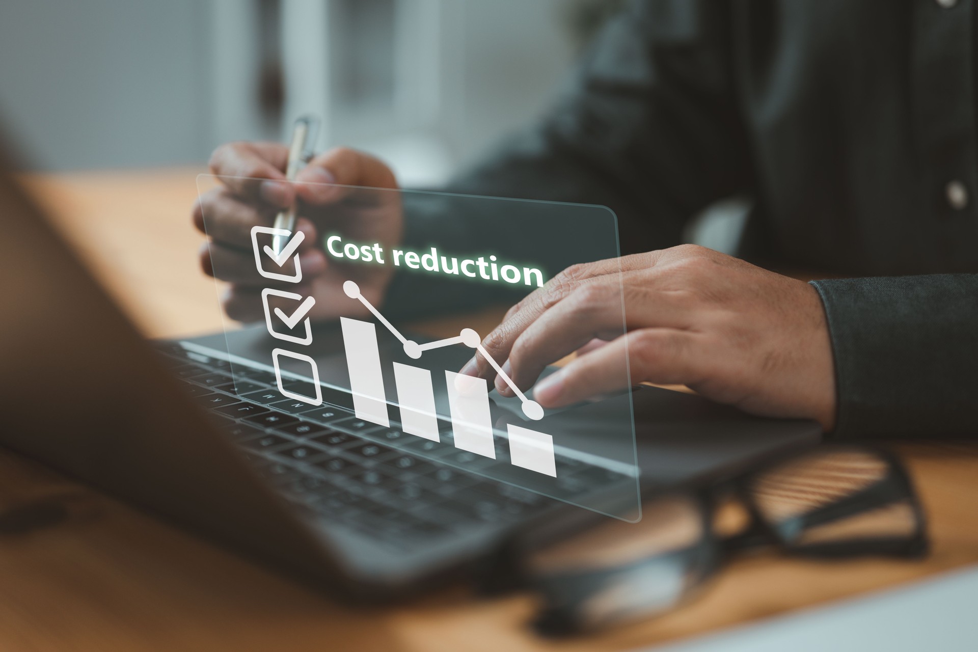 Businessman lowering the arrow of a graph, concept of cost reduction. Along with the down arrow, emphasizes the importance of effective budgeting and cost management strategies in business.